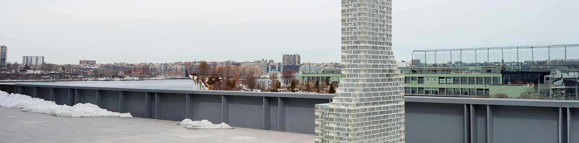 Installation view of Kelly Akashi’s Monument (Altadena) (2026), showing the glass-brick chimney installation on the Whitney Museum’s rooftop terrace.