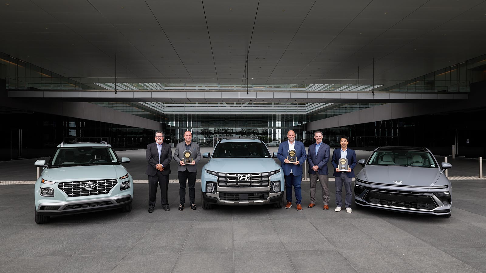 JD Power’s David Sargent, vice president and Robert Mansfield vice president, global automotive present JD Power 2026 U.S. IQS trophies to Barry Ratzlaff, chief customer officer, Natha